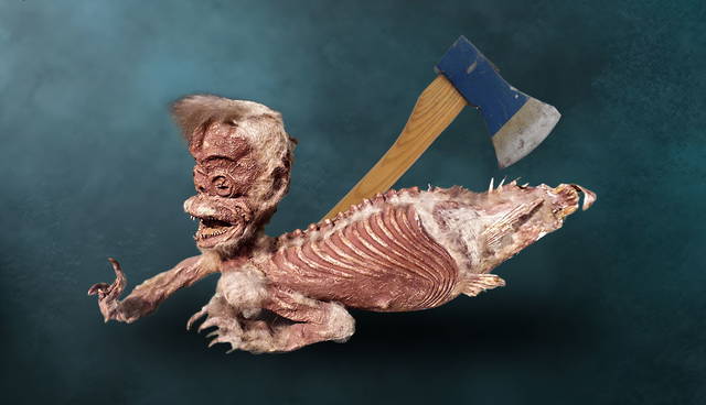 Mummified Fiji mermaid taxidermy with an axe in the background