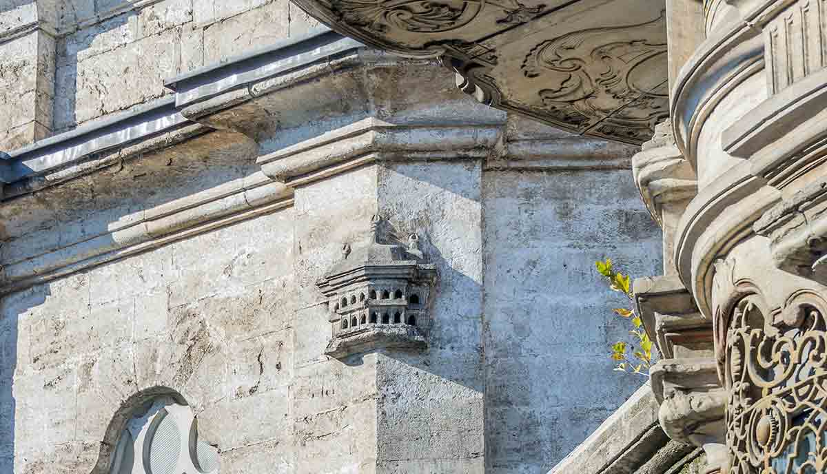 bird palace built into mosque facade
