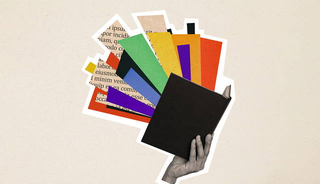 Hand holding open book with colorful pages