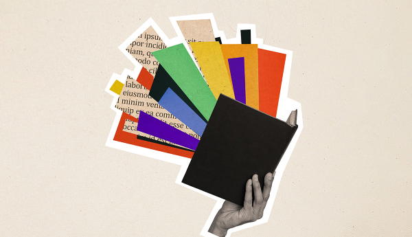 Hand holding open book with colorful pages