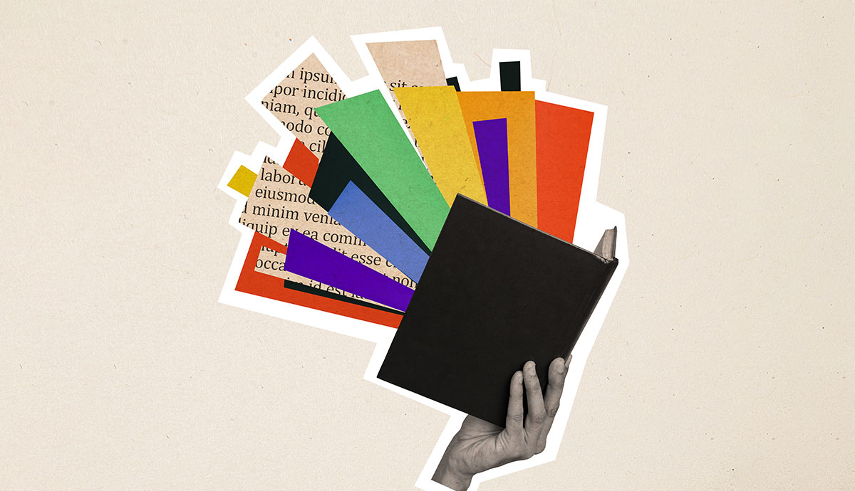 Hand holding open book with colorful pages