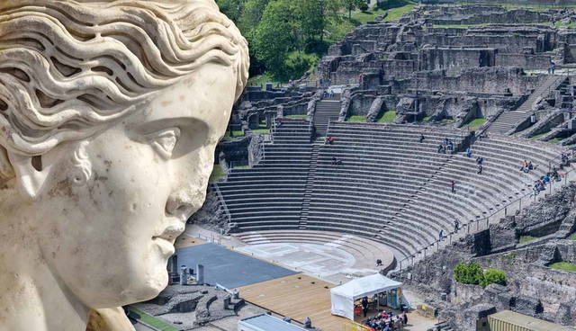 An ancient marble bust before a Roman theater.