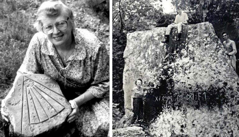 Woman holding carved stone next to runic rock.