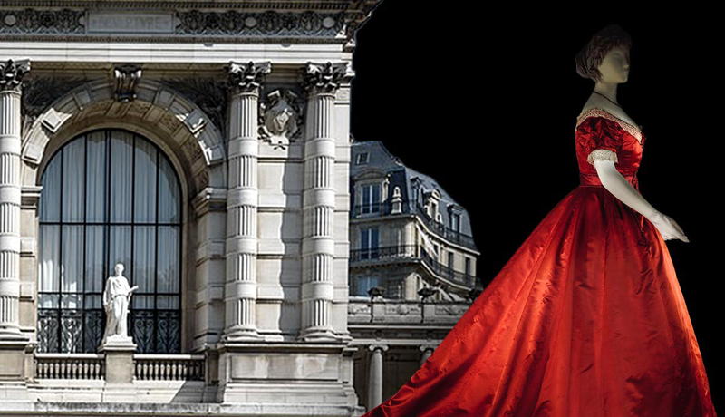 An elegant red gown before a Parisian building.