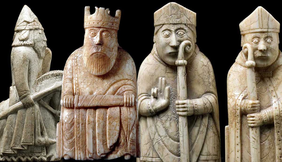 Four Lewis Chessmen figurines against a black background.
