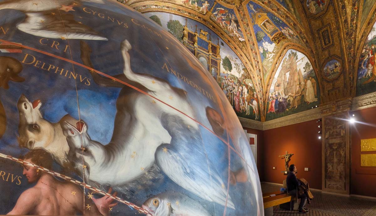 A painted celestial globe in an ornate museum hall