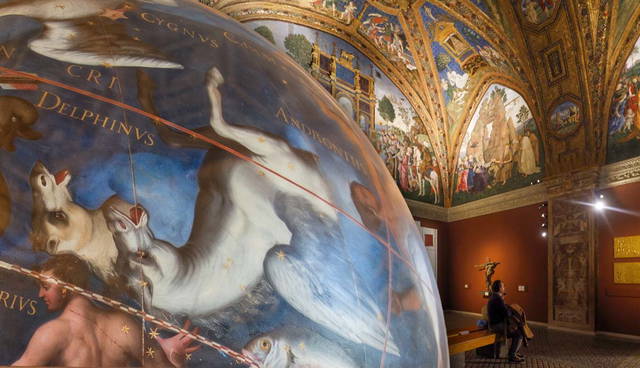 A painted celestial globe in an ornate museum hall
