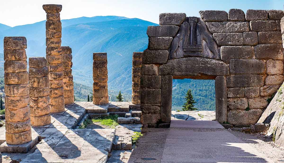 Ancient Greek ruins with stone columns and a gateway.
