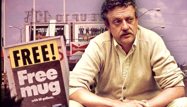 Kurt Vonnegut sitting in front of roadside signs.