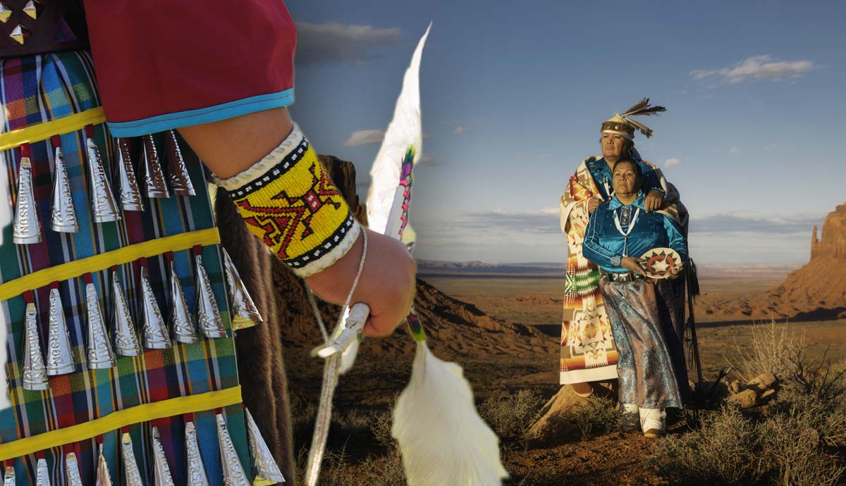Indigenous people in traditional regalia in a desert landscape