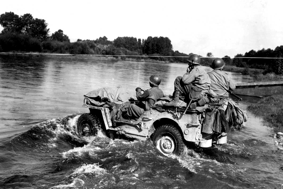 men on jeep in water