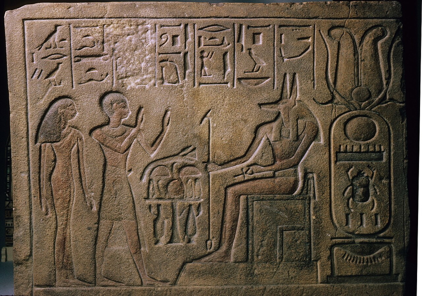 man and woman worshipping anubis
