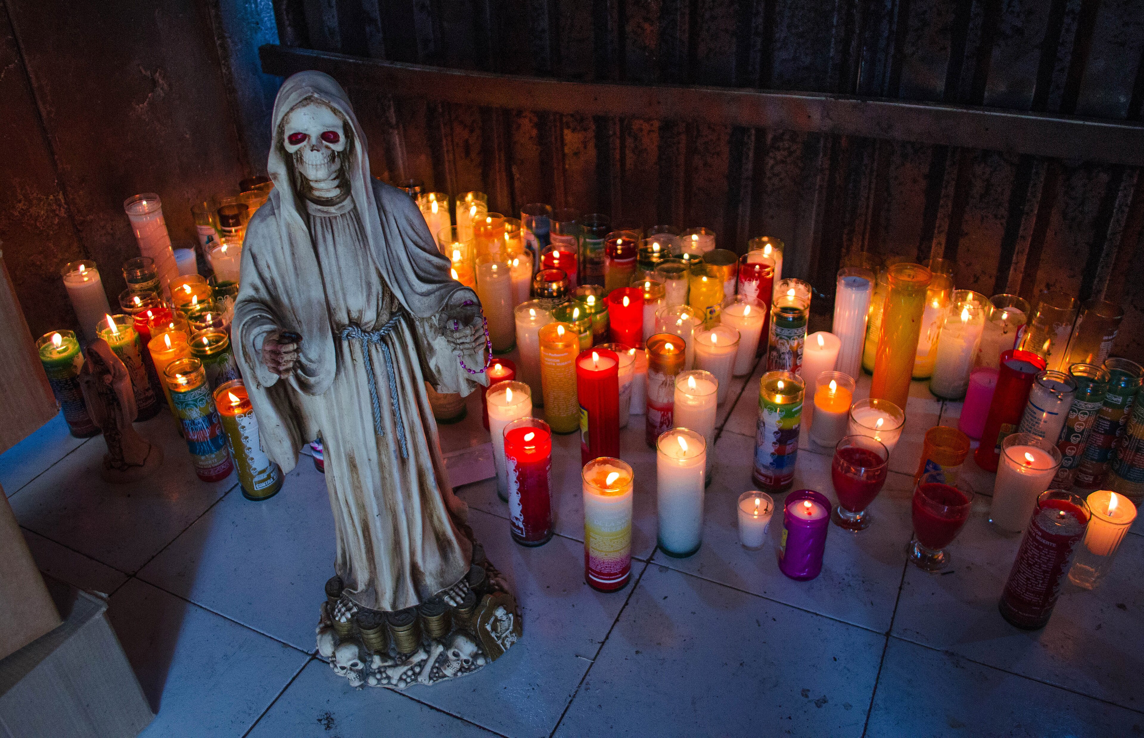 La Santa Muerte statue with candles